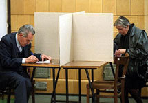 Yugoslavs fill their ballots at a polling station in downtown Belgrade, Sunday Oct.13 2002, during the runoff presidential elect