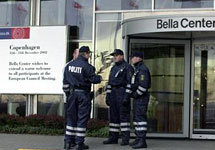 Police stand outside the main entrance of the Bella Center, which will be host of the EU Summit in Copenhagen, Denmark Wednesday